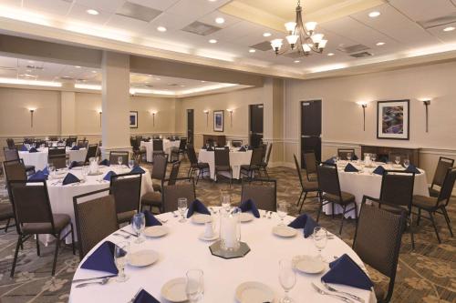a banquet hall with white tables and chairs at Embassy Suites by Hilton Portland Maine in Portland