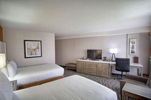 a hotel room with two beds and a desk at DoubleTree by Hilton Portland, ME in South Portland