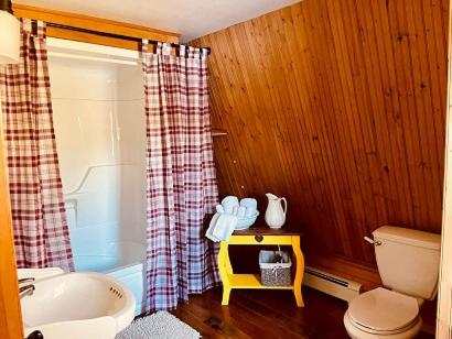 a bathroom with a sink and a toilet and a tub at Forest & Lake PEI Bed & Breakfast in Murray Harbour