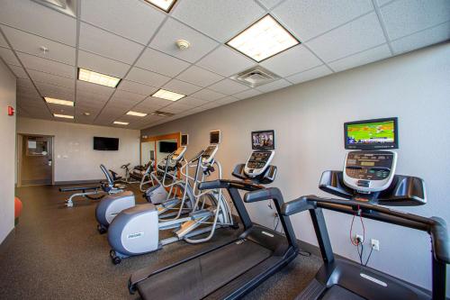 a gym with several treadmills and a row of exercise bikes at Hilton Garden Inn Rapid City in Rapid City