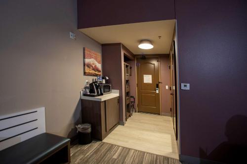 a room with a hallway with a kitchen and a microwave at Hilton Garden Inn Rapid City in Rapid City