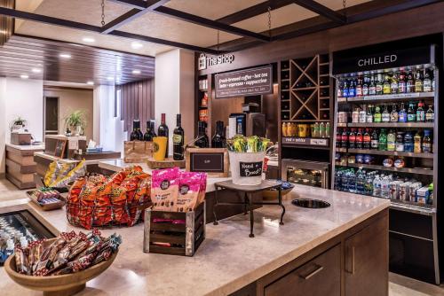 a store with a counter with bottles of alcohol at Hilton Garden Inn Bend in Bend