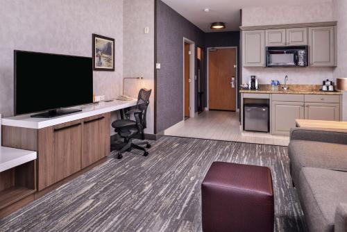 a hotel room with a desk with a flat screen tv at Hilton Garden Inn Bend in Bend