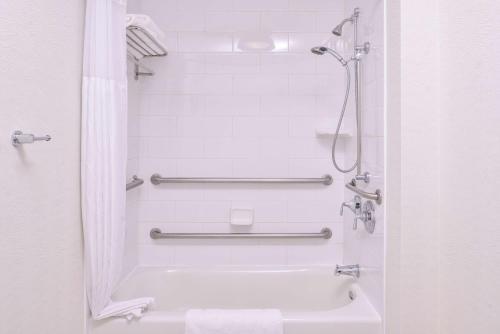 a bathroom with a shower and a tub and a sink at Hilton Garden Inn Bend in Bend