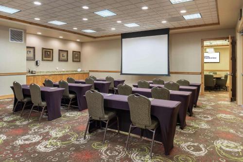 a conference room with a table and chairs and a screen at Hilton Garden Inn Bend in Bend