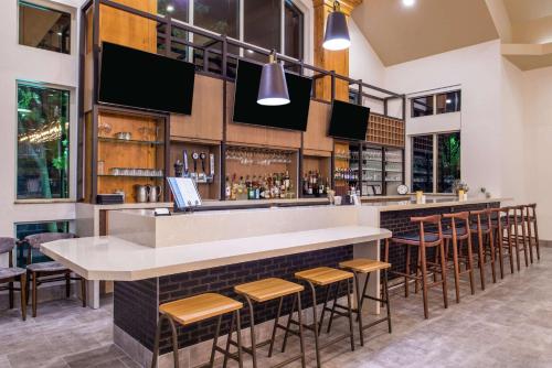 a bar in a restaurant with bar stools at Hilton Garden Inn Bend in Bend