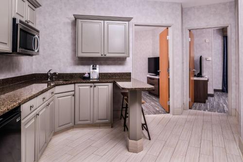 a kitchen with white cabinets and a counter top at Hilton Garden Inn Bend in Bend
