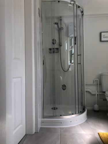 a bathroom with a shower with a glass door at Little Park Holiday Homes Self Catering Cottages 1 & 2 bedrooms available close to Tutbury Castle in Tutbury
