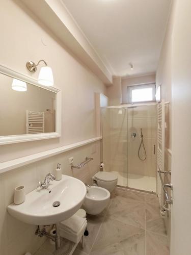 a bathroom with a sink and a toilet and a shower at Colombo 477 Auditorium in Civitanova Marche