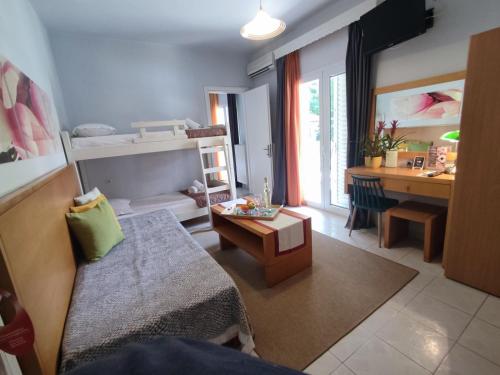 a living room with a bed and a desk in a room at Villa Riviera in Stavros
