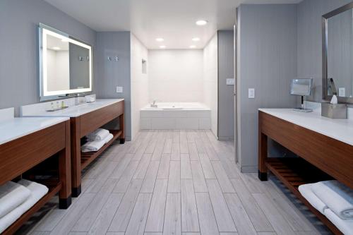 a bathroom with two sinks and a bath tub at DoubleTree by Hilton Bakersfield in Bakersfield