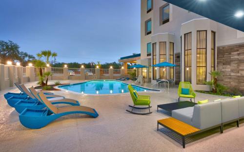 a swimming pool with lounge chairs and a building at Hampton Inn & Suites Rockport-Fulton in Rockport