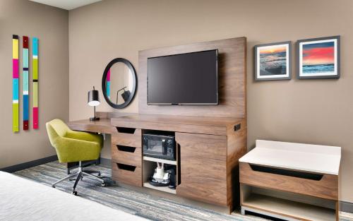 a bedroom with a desk with a television and a chair at Hampton Inn & Suites Rockport-Fulton in Rockport