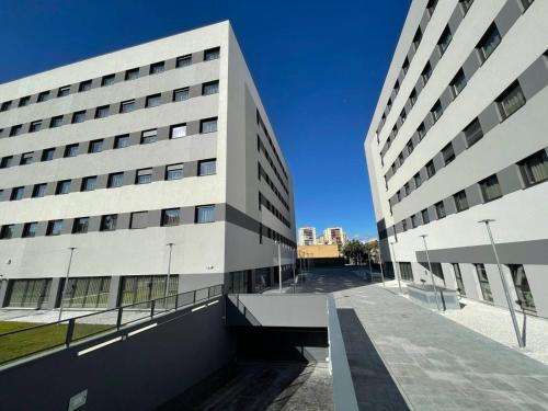 a large white building with a street in front of it at Livensa Living Studios Málaga Feria in Málaga