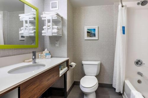 a bathroom with a sink and a toilet and a tub at Hampton Inn Carlsbad North San Diego County in Carlsbad