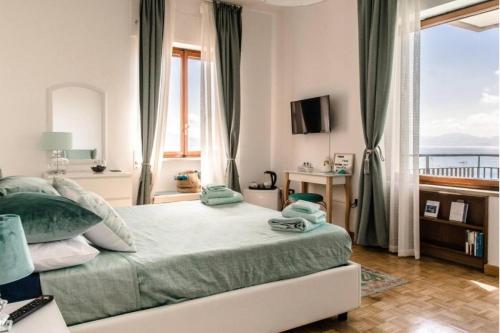 a bedroom with a bed with a view of the ocean at La Stella dei Venti B&B in Naples