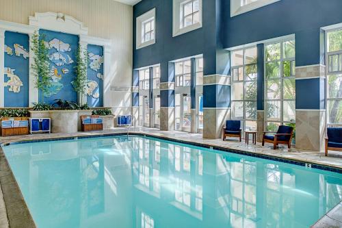 a swimming pool with blue walls and windows at Embassy Suites by Hilton San Diego Bay Downtown in San Diego