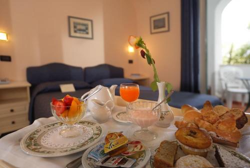 a table with a tray of breakfast food on it at Le Querce Resort Sea Thermae & Spa in Ischia