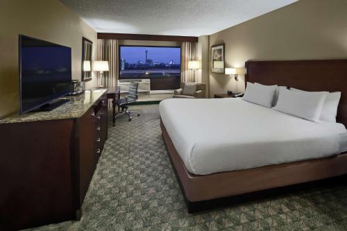a hotel room with a bed and a flat screen tv at DoubleTree by Hilton San Antonio Downtown in San Antonio