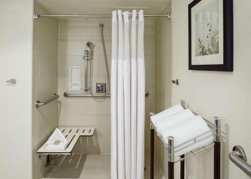 a bathroom with a shower with a white shower curtain at DoubleTree by Hilton San Antonio Downtown in San Antonio