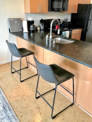 two chairs sitting at a kitchen counter with a sink at Greensview Apt 2 Bedroom, 2 Bath - Beautiful views! in Charlottesville