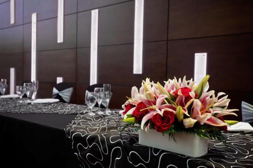 a table with a bouquet of flowers on top of it at DoubleTree by Hilton Hotel South Bend in South Bend