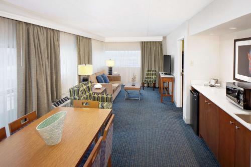 a room with a living room and a hotel room at DoubleTree by Hilton Hotel South Bend in South Bend