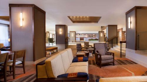 a lobby with couches and tables and chairs at Hilton Sedona Resort at Bell Rock in Sedona