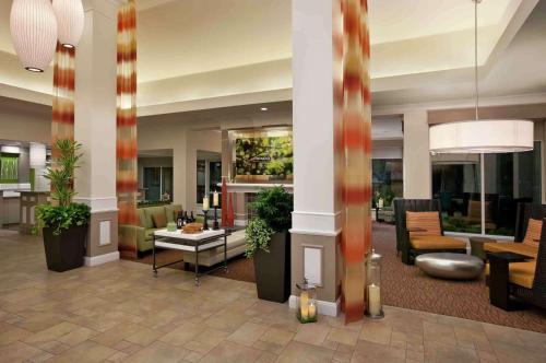 a lobby of a hotel with chairs and tables at Hilton Garden Inn San Francisco Airport North in South San Francisco
