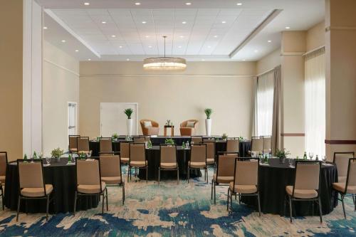 a meeting room with tables and chairs in a room at Embassy Suites by Hilton San Juan - Hotel & Casino in San Juan