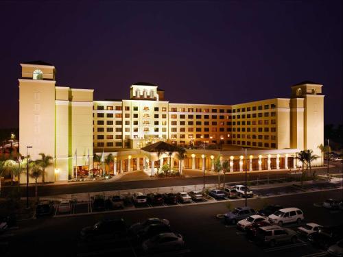 a large building with cars parked in a parking lot at DoubleTree Suites By Hilton Anaheim Resort/Convention Center in Anaheim