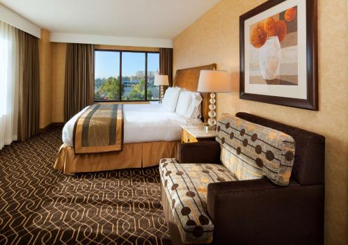 a hotel room with a bed and a couch at DoubleTree Suites By Hilton Anaheim Resort/Convention Center in Anaheim