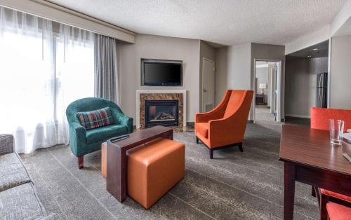a living room with furniture and a fireplace at Homewood Suites by Hilton Olmsted Village in Pinehurst