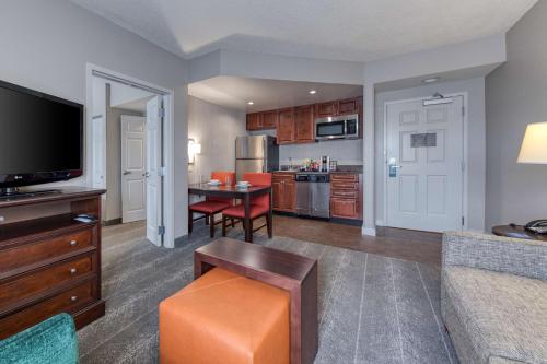a living room with a kitchen and a dining room at Homewood Suites by Hilton Olmsted Village in Pinehurst