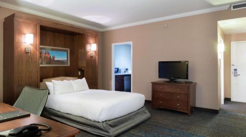 a hotel room with a bed and a television at Hilton Saint John in Saint John