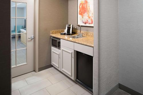 a kitchen with a sink and a counter top at Hilton Garden Inn Sioux City Riverfront in Sioux City