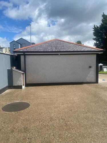 a large white garage with a roof at St Columbs House in Buncrana