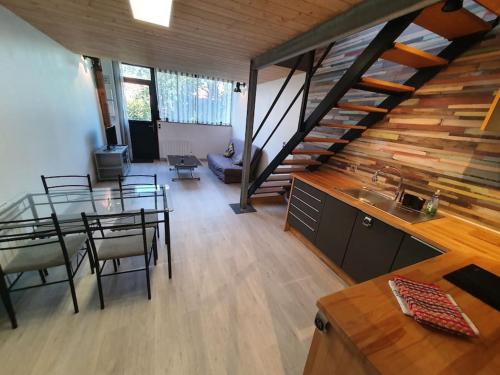 a dining room with a table and a staircase at APPARTEMENT CENTRE VILLE AU CALME JARDIN et PARKING PUBLIC in La Rochelle