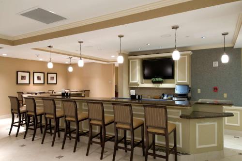 a bar in a restaurant with a bunch of chairs at Hilton Garden Inn Mount Holly/Westampton in Westampton Township