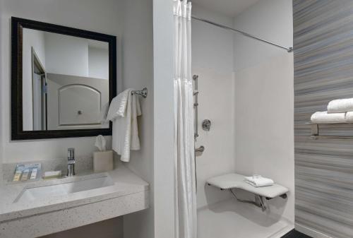a white bathroom with a sink and a mirror at Hilton Garden Inn Hamilton in Bordentown