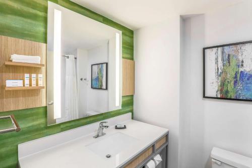 a bathroom with a sink and a mirror at Hilton Garden Inn Tulsa South in Tulsa