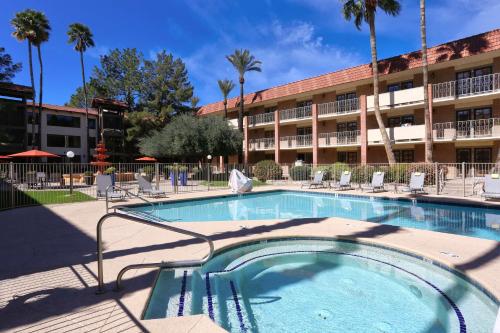 a swimming pool in front of a hotel at DoubleTree Suites by Hilton Tucson Airport in Tucson