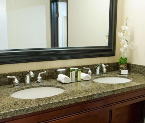 a bathroom with two sinks and a large mirror at DoubleTree Suites by Hilton Tucson Airport in Tucson