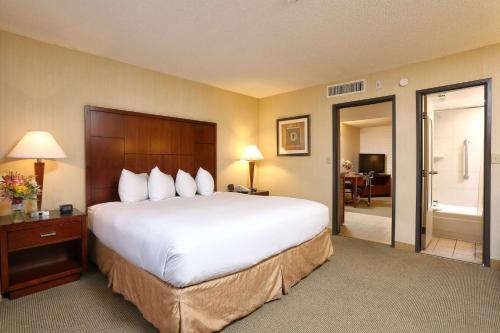 a hotel room with a large bed and a bathroom at DoubleTree Suites by Hilton Tucson Airport in Tucson