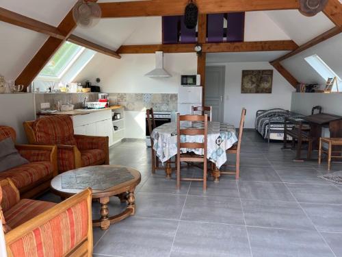 a living room with a couch and a table at Kerrouz in Bannalec