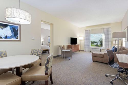 a living room with a table and chairs and a couch at Hampton Inn & Suites Wellington in Wellington