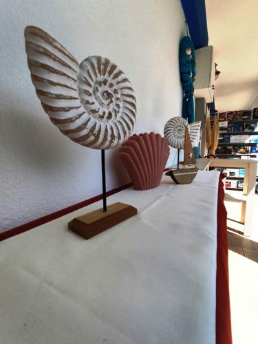 two sculptures of a shell on a table at Villa Riviera in Stavros