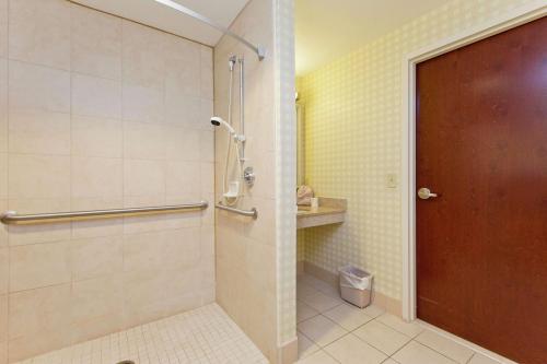 a bathroom with a shower with a glass door at Hilton Garden Inn Winchester in Winchester