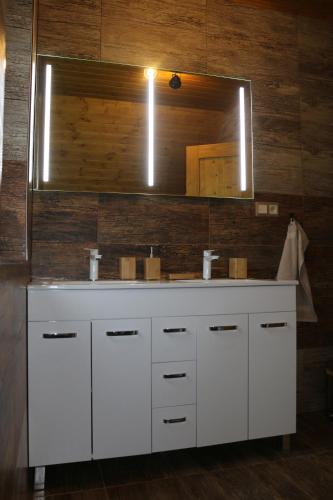 a bathroom with a white sink and a mirror at Pinus Cembra in Stará Lesná