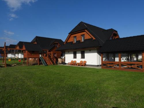 a row of houses with a green lawn at Pinus Cembra in Stará Lesná